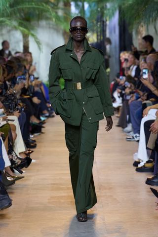 Spring Trouser Trends 2025: A model wears a pair of refined cargo trousers on the Elie Saab runway