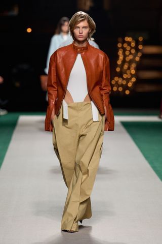 Spring Trouser Trends 2025: A model wears chinos on the Victoria Beckham runway