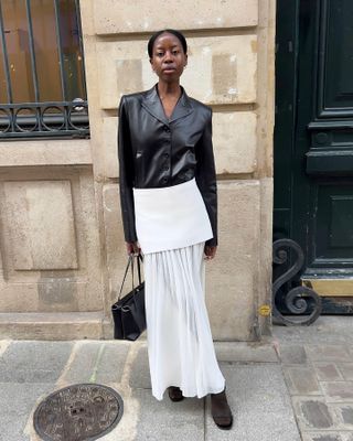 Fashion influencer @sylviemus_ in Europe wearing a chic outfit for 2025 styled with a blazer.