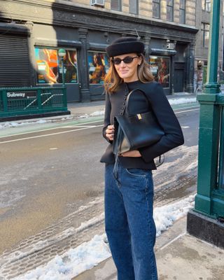 A street style image of a chic woman wearing an on-trend outfit on the streets of New York City.