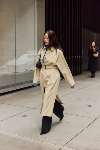 A street style image of a chic woman wearing an on-trend outfit on the streets of New York City during fashion week.