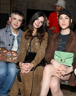 Cole Escola, Emily Ratajkowski and Tommy Dorfman sit on the Coach spring/summer 2025 runway front row