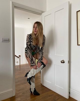 French woman wearing Western boots with sheer top.