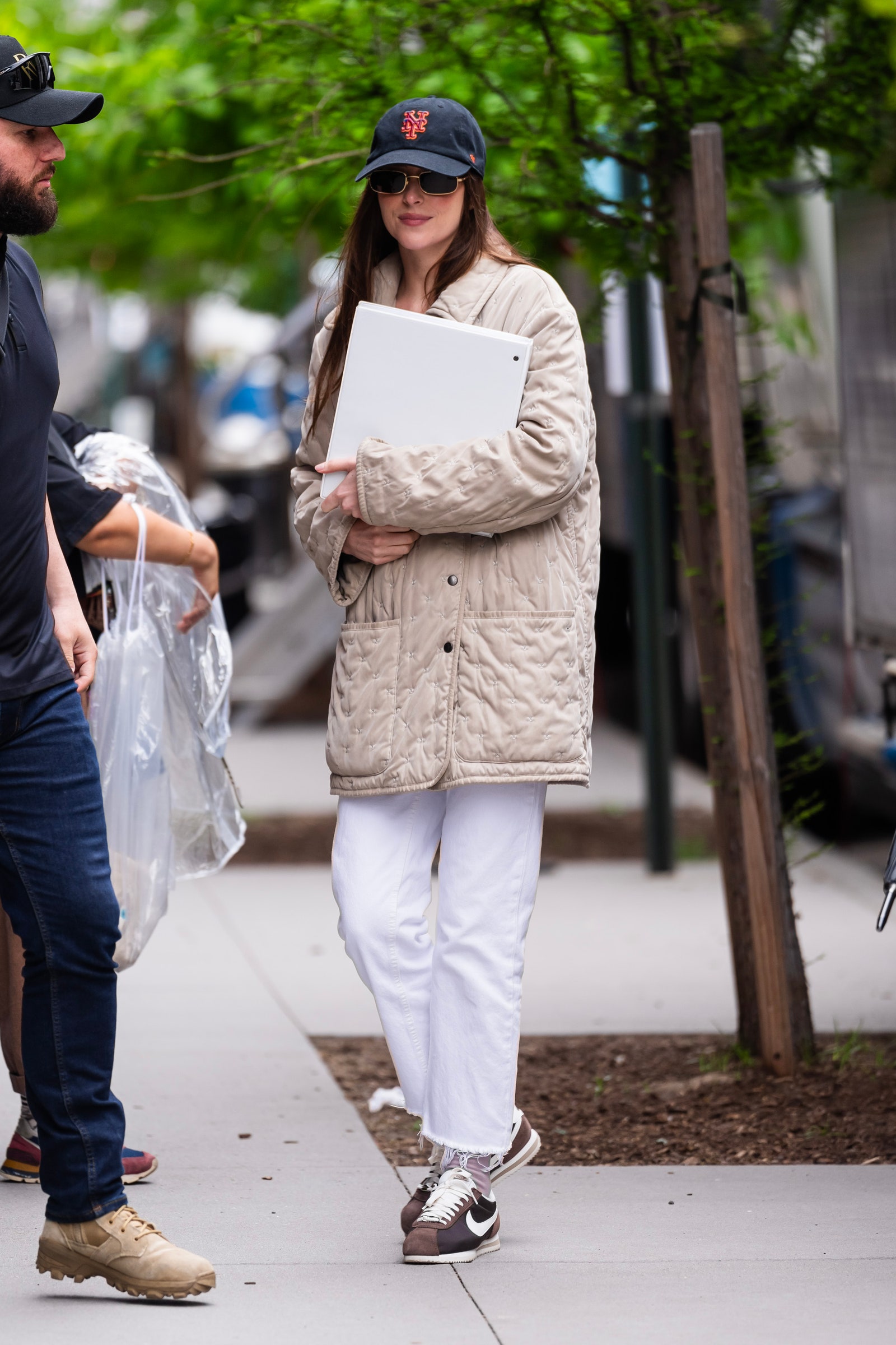 Image may contain Dakota Johnson Charlie Blackmon Clothing Pants Pedestrian Person Hat Adult Footwear and Shoe