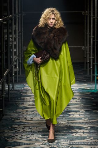 a Prada model wearing a fur-collar coat on the fall/winter 2025 runway during Milan Fashion Week