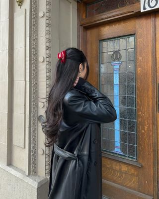 Mobina Peiman with chocolate-colored curls in a cherry red claw clip.