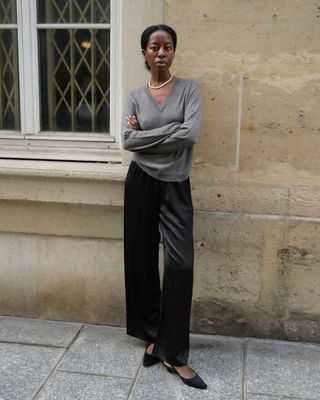 @sylviemus_ wearing black silk trousers and jumper