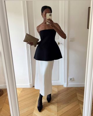 Sylvie in a white skirt and black bandeau top