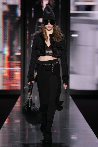 Model wearing all black at dolce & Gabbana f/w 25 show.