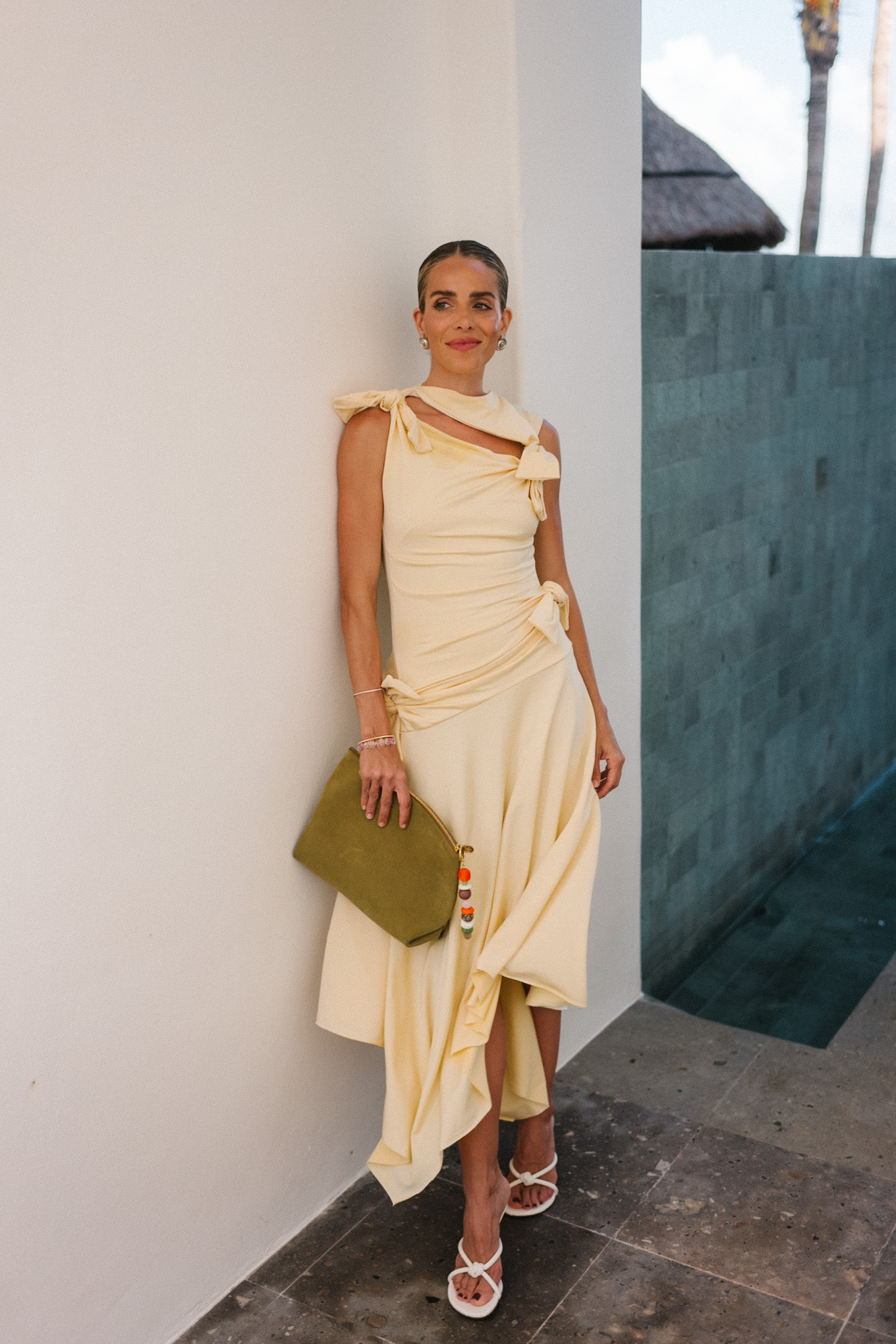 yellow cutout crepe midi dress green bag white heels