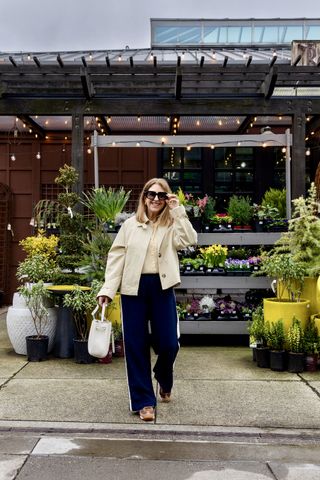 A Nordstrom stylist wearing track pants and neutral sneakers.