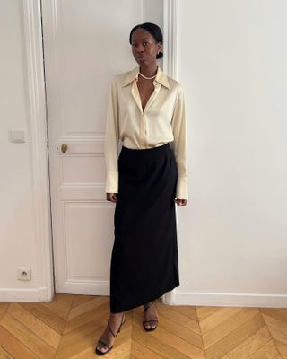 Influencer wearing a satin yellow top and long black skirt