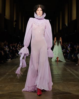 A model wearing an iced lilac translucent gown at the Alexander McQueen F/W 25 show during Paris Fashion Week.