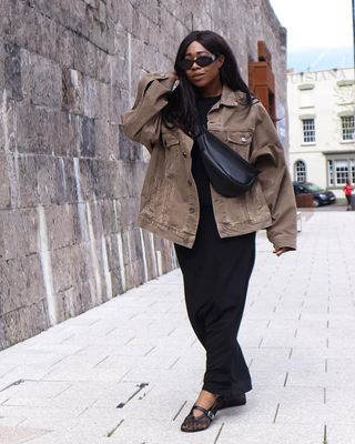 Lois in a khaki denim jacket and black mesh ballet flats