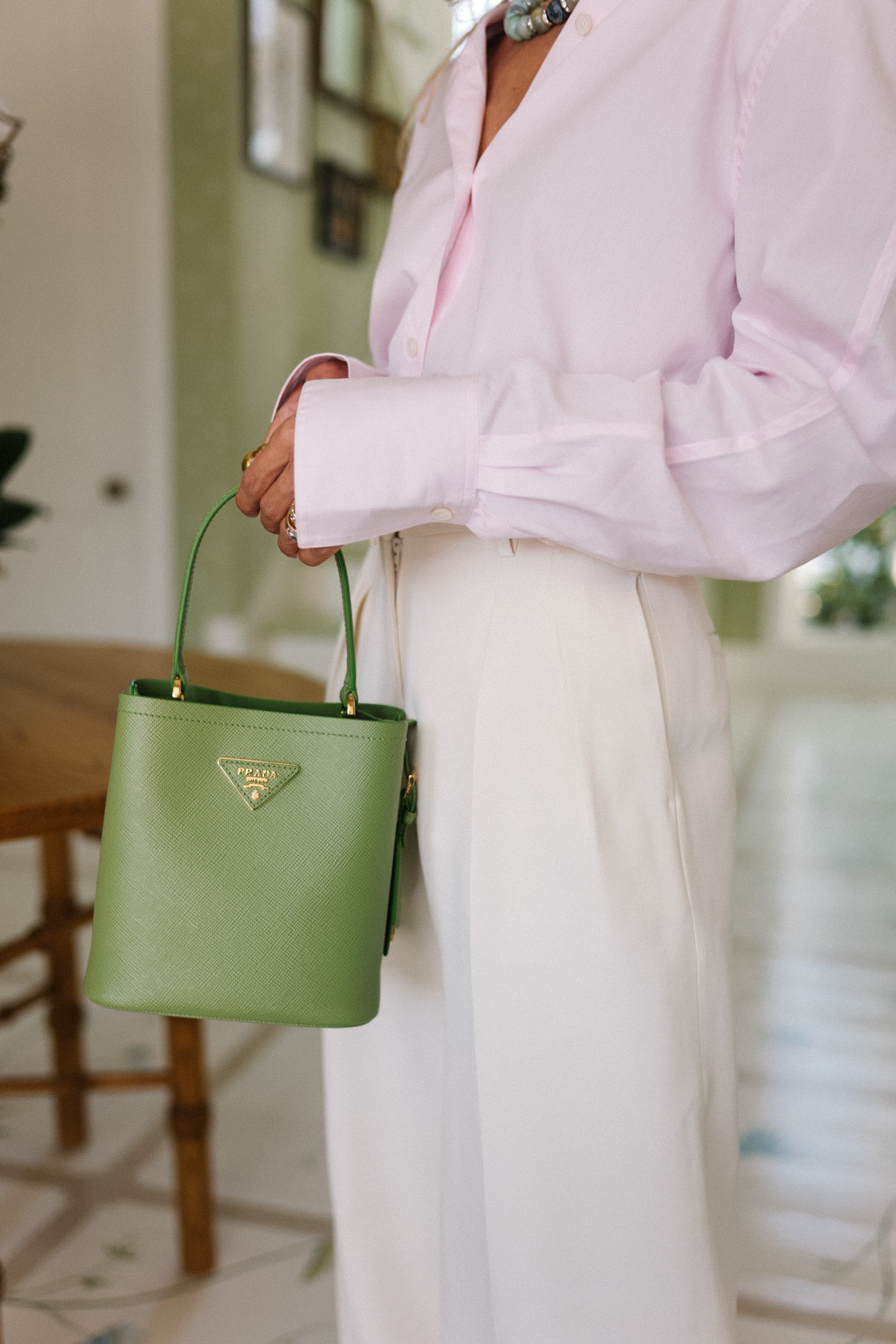 lavender poplin button up shirt white crepe tapered pants green handbag