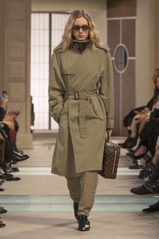 A model wearing a funnel-neck trench coat at the Louis Vuitton F/W 25 show.