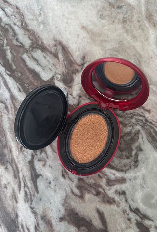 TirTir mask fit red cushion foundation compact on marble surface