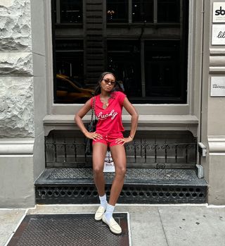 woman wearing red t-shirt and shorts with loafers spring outfit