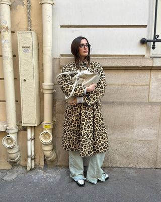 woman wearing leopard long coat with jeans and loafers spring outfit