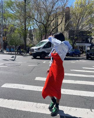 woman wearing red slip dress and sneakers outfit