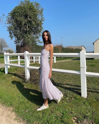 woman wearing white polka dot slip dress and sneakers outfit