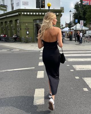 woman wearing black slip dress and sneakers outfit