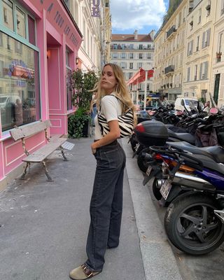 woman wearing white top and light black jeans