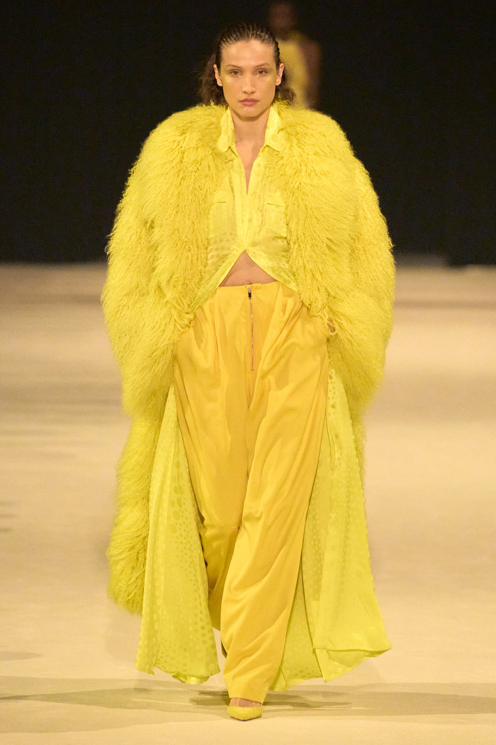 At Christopher John Rogers resort 2024 show elegant trousers with cargo pockets ground a yellow monochromatic look.