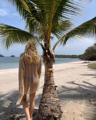 woman wearing silk headscarf and crochet dress on vacation