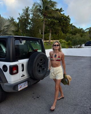 Influencer wearing a swimsuit and yellow shorts