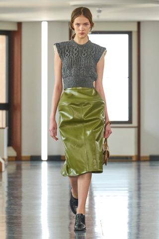 A gray vest and green leather pencil skirt from the F/W 25 Bally runway collection.