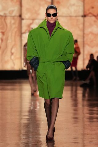 A green coat from the F/W 25 YSL runway collection.