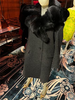 A gray coat with a fur collar from the F/W 25 Prada runway collection.