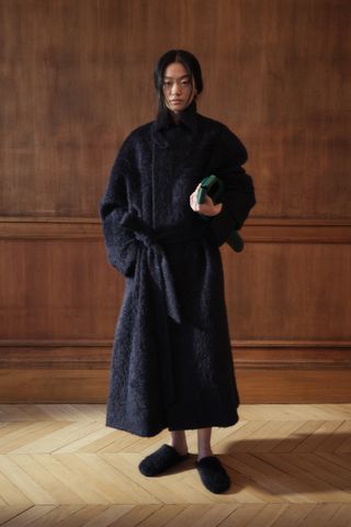 A long navy blue coat from the F/W 25 Carven collection.