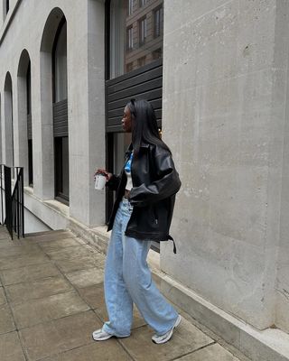 woman wearing white sneakers with spring denim outfit