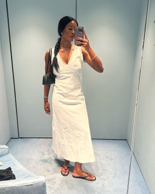 @nlmarilyn wearing a white cotton dress with an Alaïa bag and flip flops.